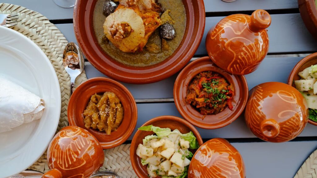 Traditional Moroccan dinner served in tagines at an Agafay Desert camp near Marrakech