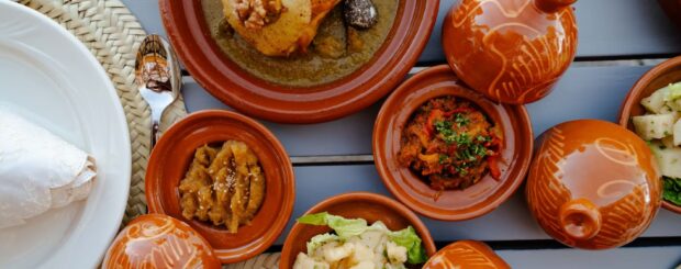 Traditional Moroccan dinner served in tagines at an Agafay Desert camp near Marrakech