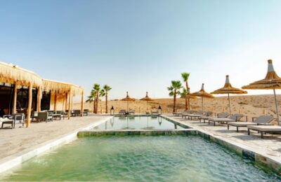 Agafay Desert camp with swimming pool and shaded lounge area near Marrakech
