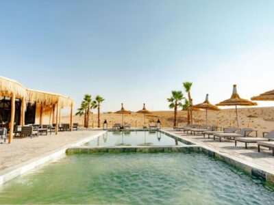 Agafay Desert camp with swimming pool and shaded lounge area near Marrakech