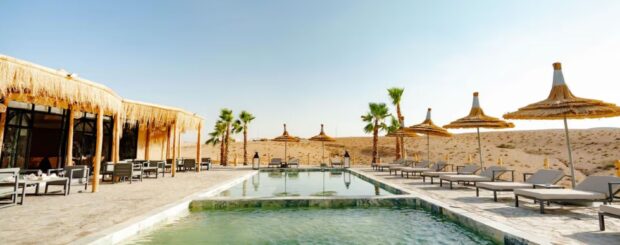 Agafay Desert camp with swimming pool and shaded lounge area near Marrakech