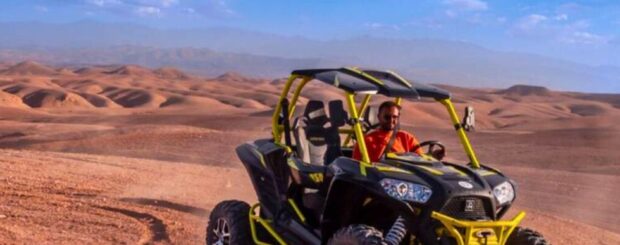 Two travelers enjoying a buggy safari tour through the Agafay Desert near Marrakech, Morocco.