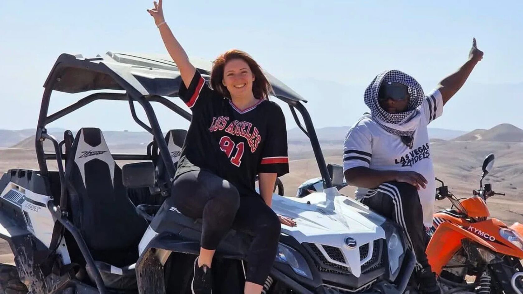 Buggy driving through the Agafay Desert at sunset near Marrakech, Morocco.