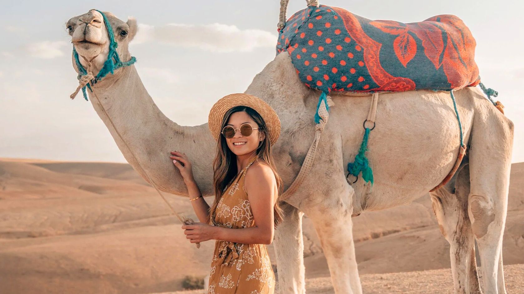 Woman enjoying a camel excursion in the Agafay Desert near Marrakech, Morocco.