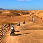 Group of travelers enjoying a quad biking adventure across the Agafay Desert near Marrakech.