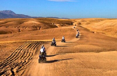 Group of travelers enjoying a quad biking adventure across the Agafay Desert near Marrakech.