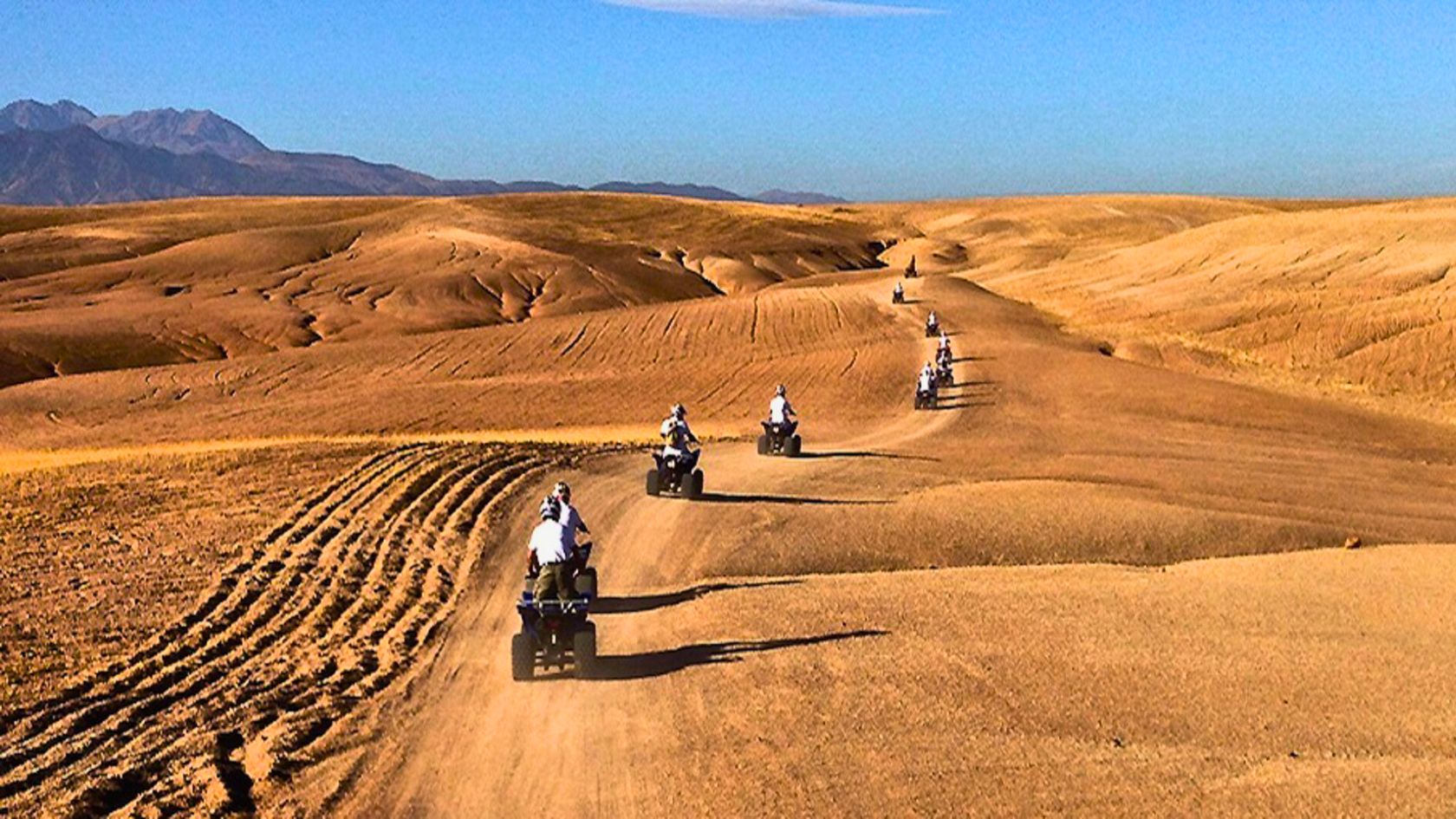 Group of travelers enjoying a quad biking adventure across the Agafay Desert near Marrakech.